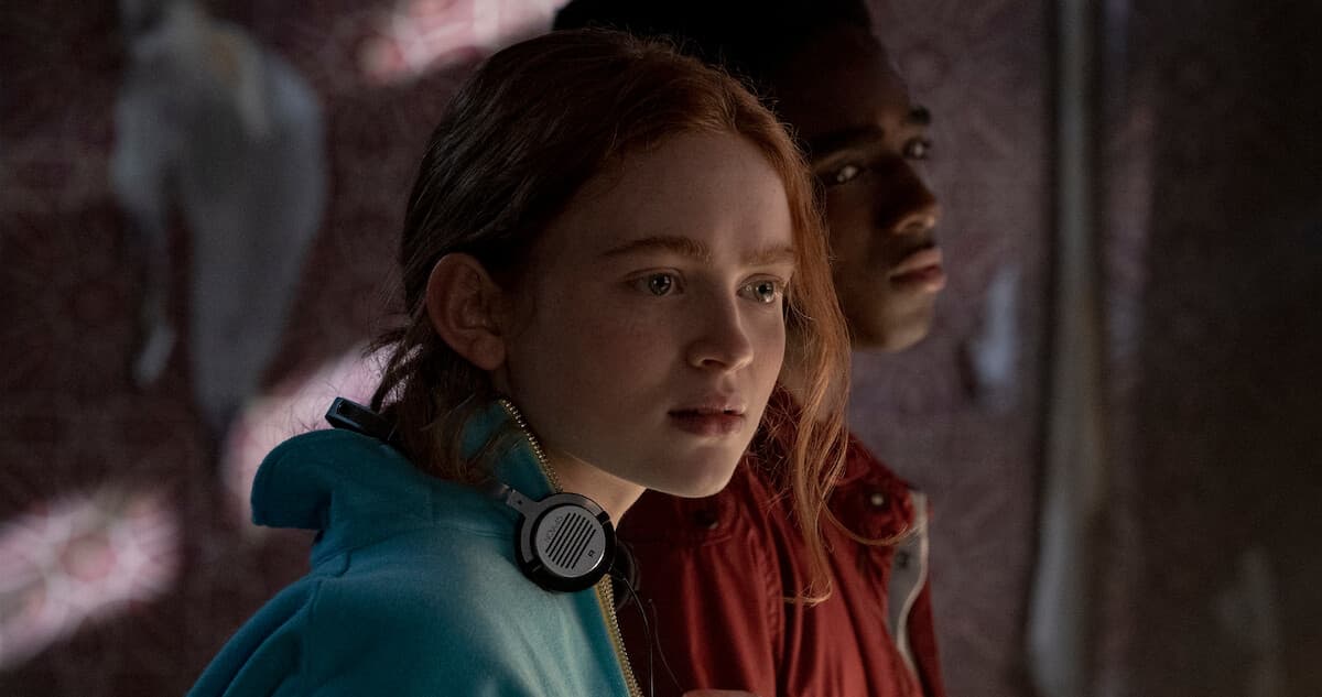 Sadie Sink as Max Mayfield with her headphones in Stranger Things 4.